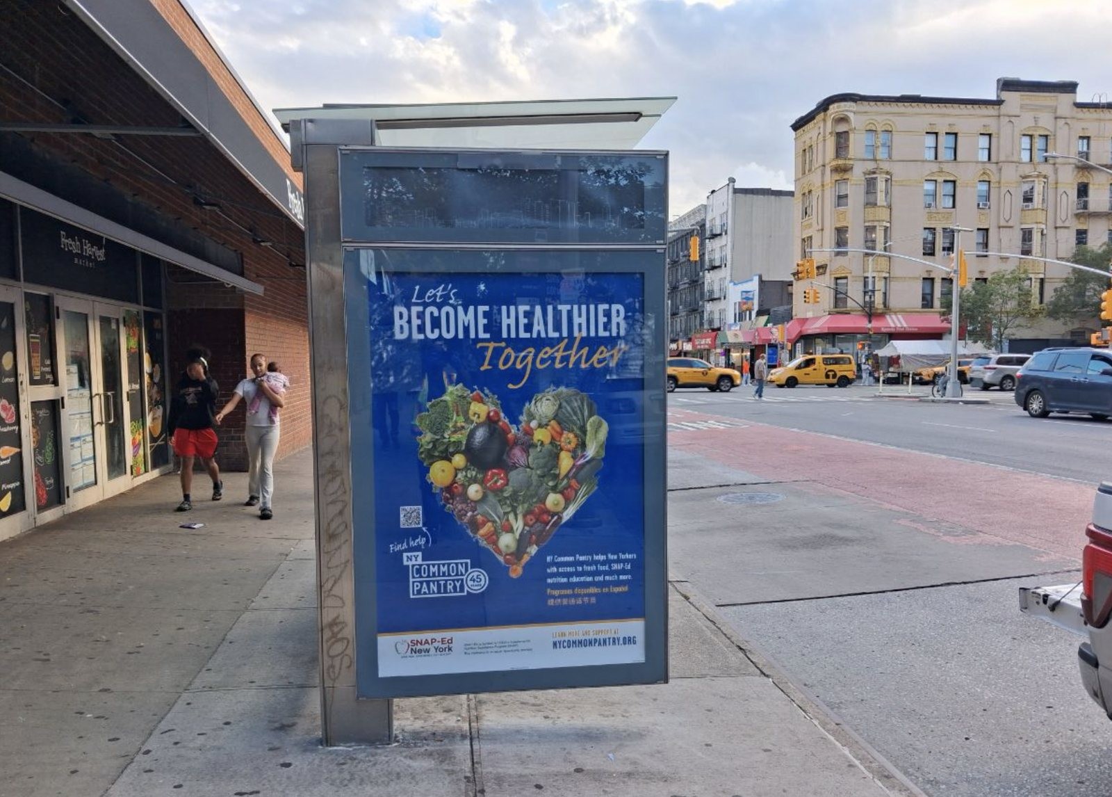NY Common Pantry bus shelter ad reading Let's Become Healthier Together on a New York City street