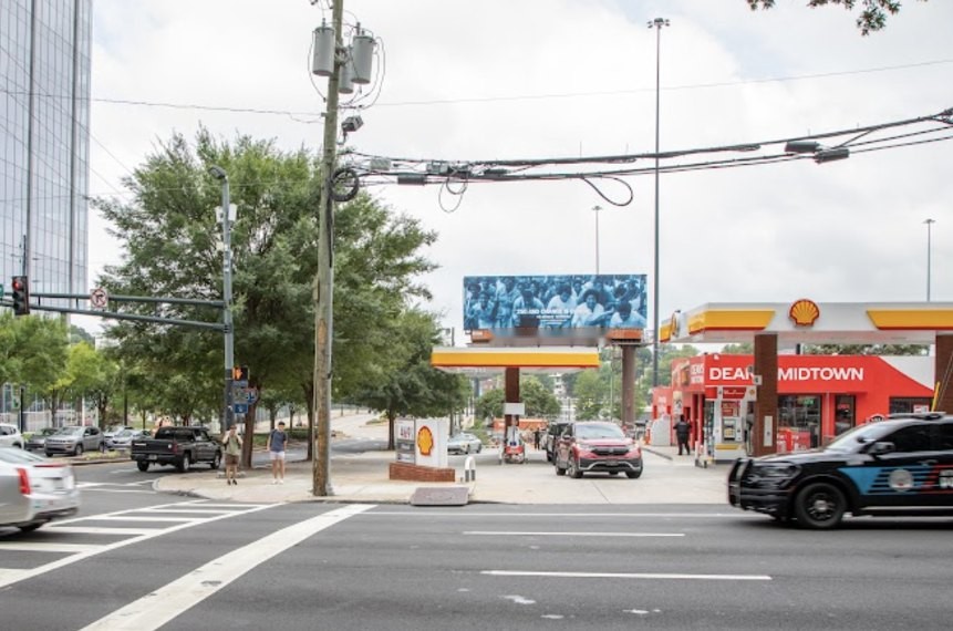 Street view of the Carrie Mae Weems bulletin over a Midtown Atlanta intersection