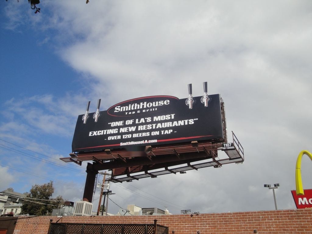 SmithHouse Tap and Grill billboard with oversized beer tap extensions on top, Santa Monica Boulevard, Los Angeles